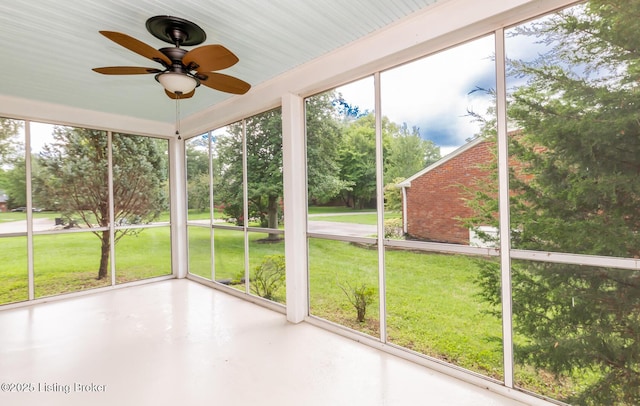 unfurnished sunroom featuring ceiling fan