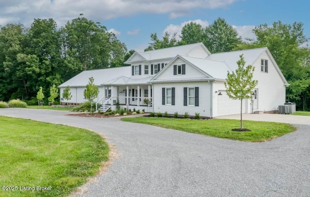 view of front facade featuring a front yard, a porch, a garage, and central air condition unit