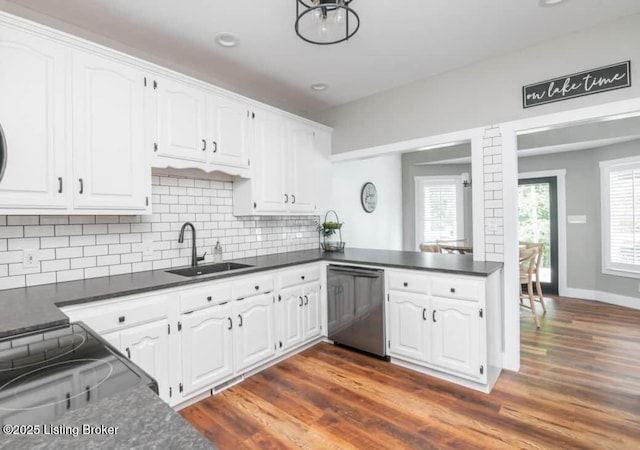 kitchen featuring dishwasher, dark wood-type flooring, white cabinets, sink, and decorative backsplash