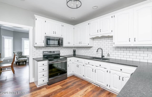 kitchen featuring white cabinetry, sink, dark wood-type flooring, and appliances with stainless steel finishes