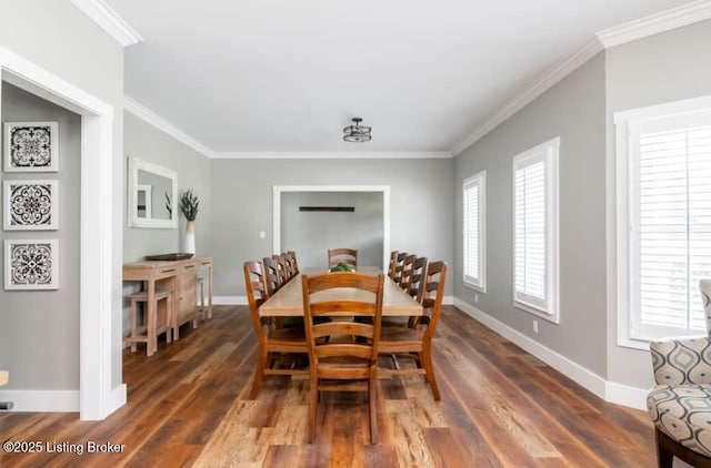 dining space with dark hardwood / wood-style flooring and crown molding