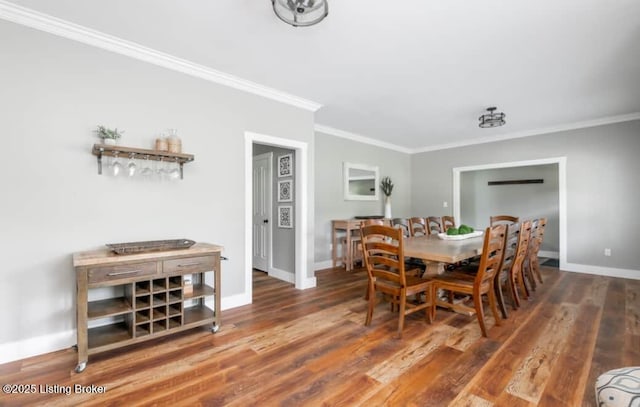 dining space with dark hardwood / wood-style flooring and crown molding