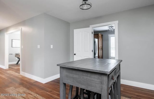 dining space featuring dark wood-type flooring