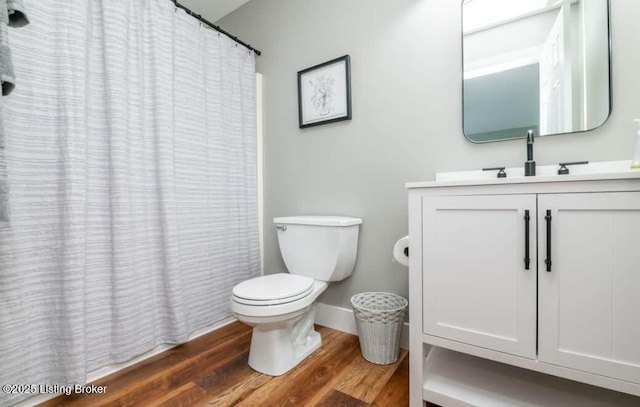 bathroom featuring hardwood / wood-style floors, vanity, and toilet