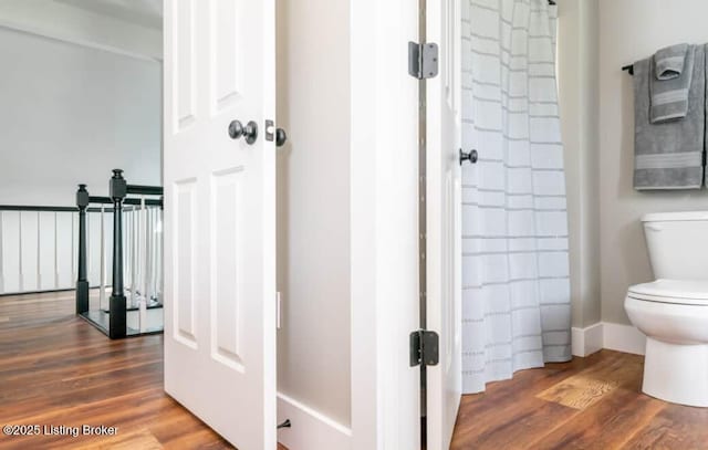 bathroom with wood-type flooring and toilet