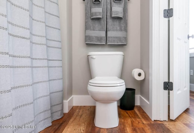 bathroom with wood-type flooring and toilet