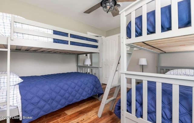 bedroom with ceiling fan and hardwood / wood-style flooring