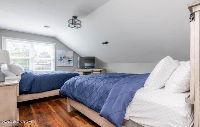 bedroom featuring dark hardwood / wood-style floors and lofted ceiling