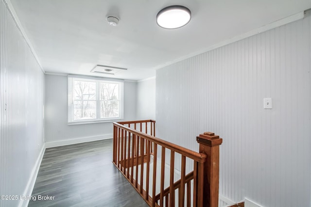 corridor featuring dark hardwood / wood-style flooring and crown molding