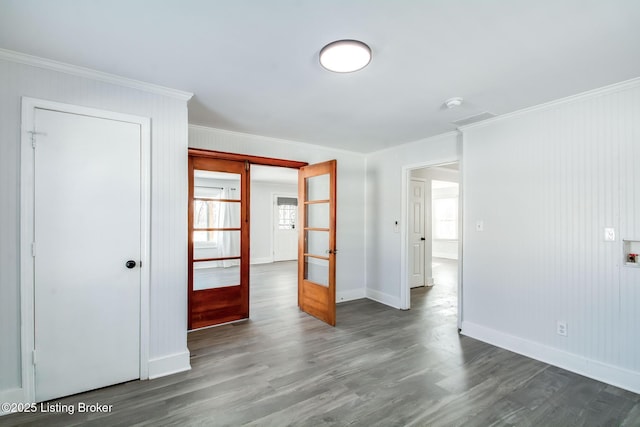 unfurnished room with french doors, crown molding, and dark hardwood / wood-style floors