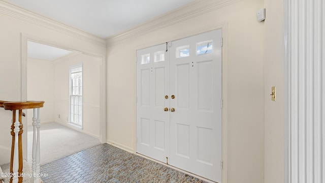 carpeted foyer with ornamental molding