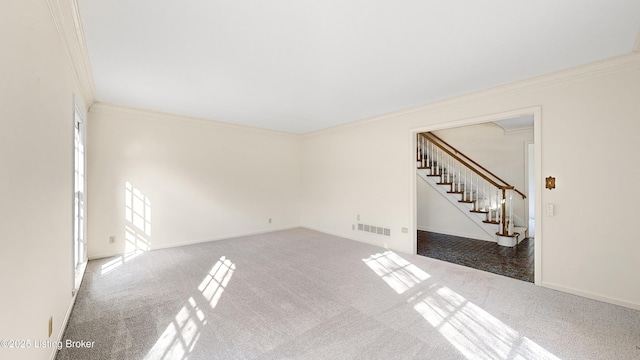 carpeted spare room with crown molding and a healthy amount of sunlight