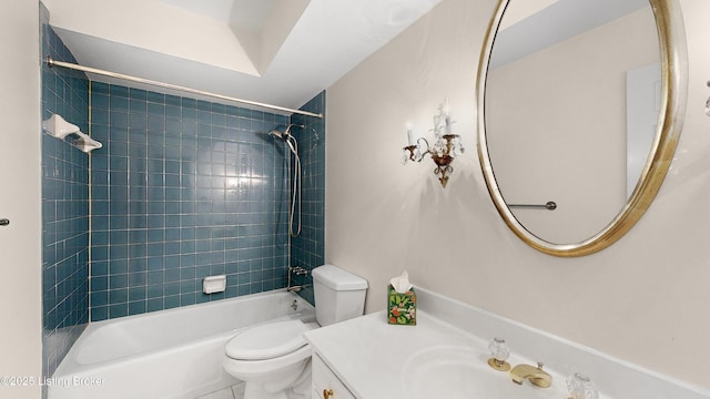 full bathroom with tiled shower / bath, vanity, and toilet