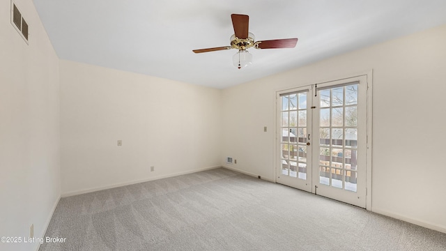 spare room featuring light colored carpet and ceiling fan