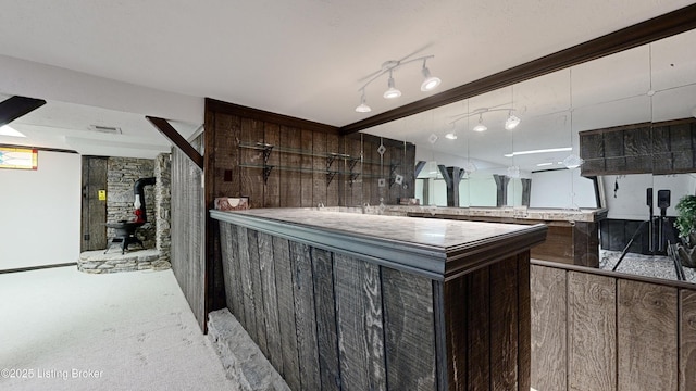 kitchen featuring dark brown cabinets and a wood stove