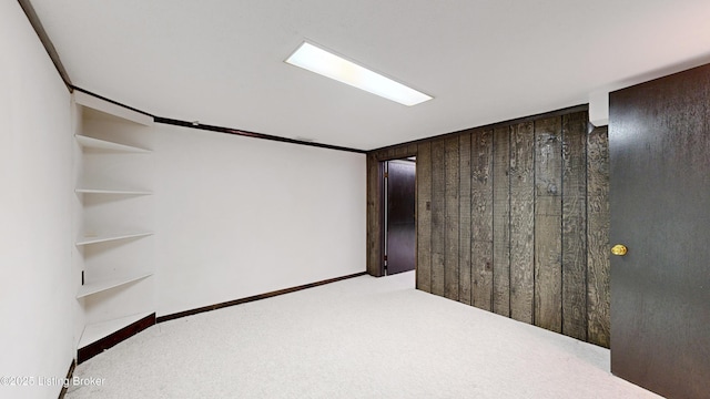 basement featuring wooden walls and carpet