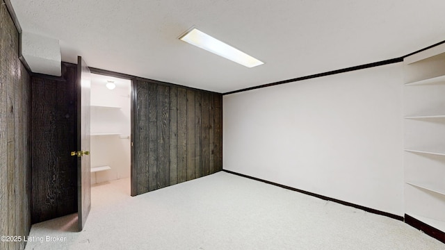 interior space featuring wooden walls and light colored carpet