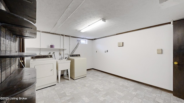 clothes washing area featuring washer and dryer and a textured ceiling