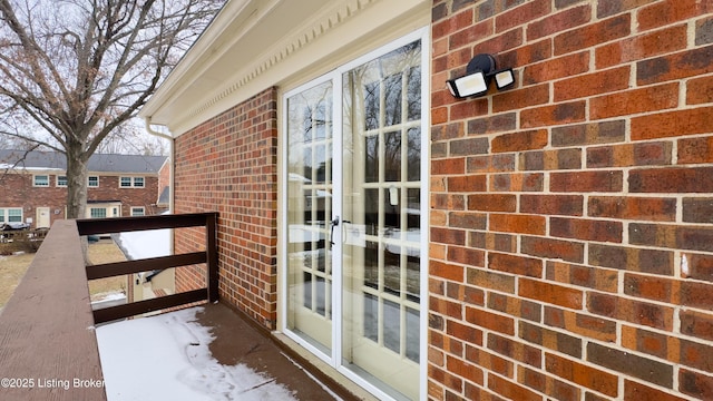 view of snow covered back of property