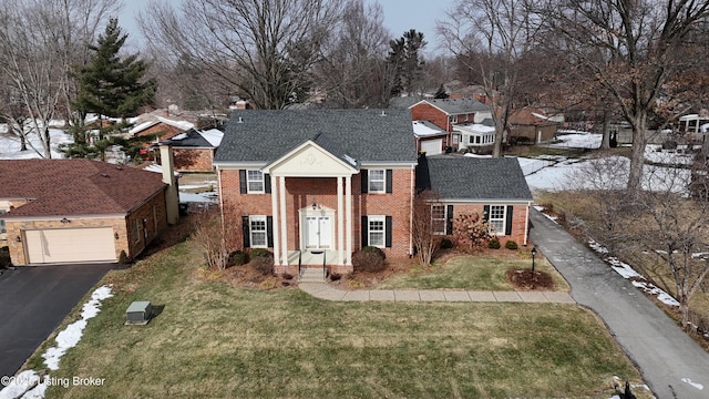 view of front of house with a garage and a front lawn