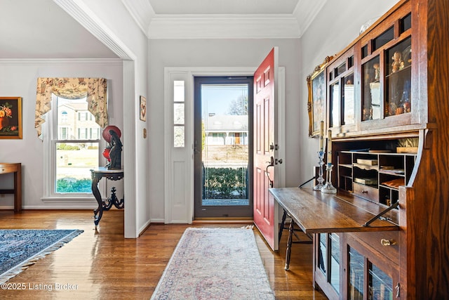 entrance foyer with hardwood / wood-style floors and ornamental molding