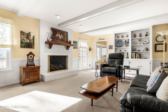 carpeted living room featuring a fireplace, plenty of natural light, and beamed ceiling