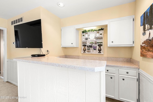 kitchen featuring white cabinetry and kitchen peninsula