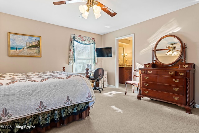 carpeted bedroom featuring ceiling fan and ensuite bath