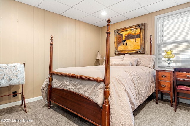 carpeted bedroom with a paneled ceiling