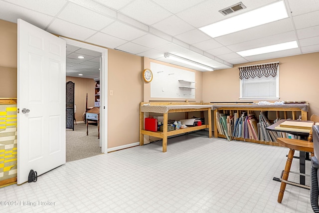 interior space featuring a paneled ceiling and a workshop area