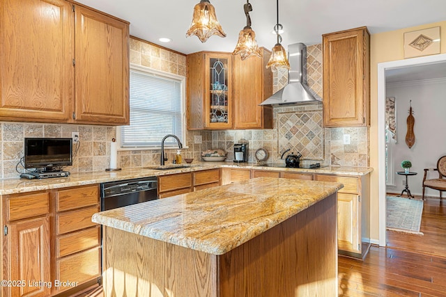 kitchen featuring black appliances, sink, a kitchen island, and wall chimney range hood