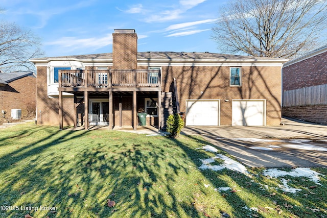 rear view of property with a garage, a patio area, central air condition unit, a yard, and a deck