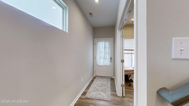 doorway featuring hardwood / wood-style flooring and a wealth of natural light