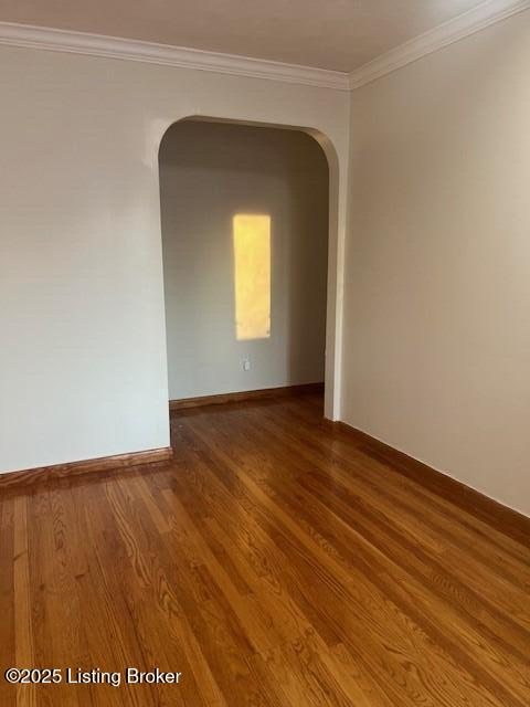 unfurnished room with hardwood / wood-style floors and crown molding