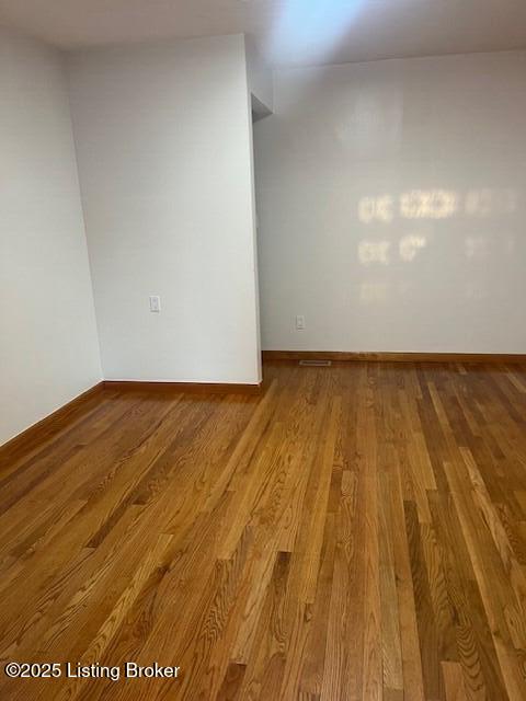 spare room with hardwood / wood-style flooring