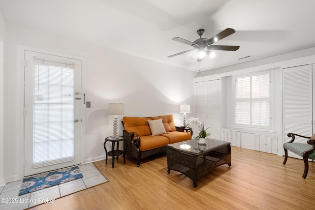 living room with light wood-type flooring and ceiling fan