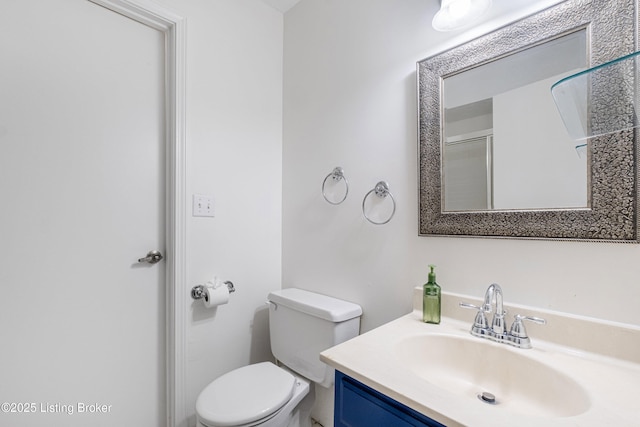 bathroom featuring toilet and vanity