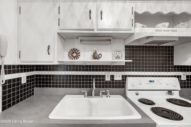 kitchen featuring white range with electric cooktop, white cabinets, decorative backsplash, and sink