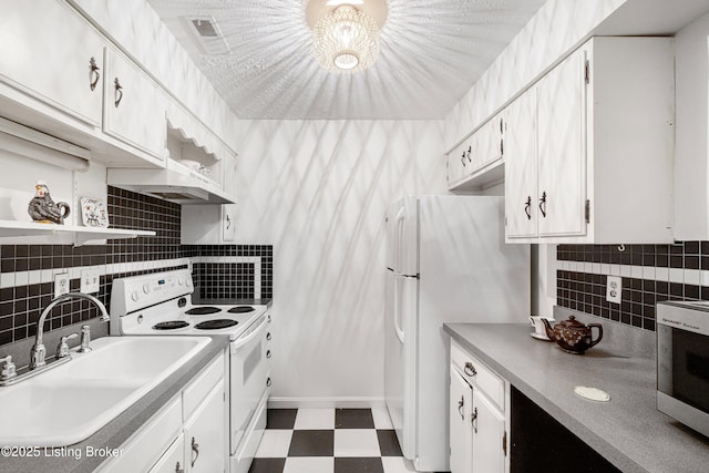 kitchen with white appliances, white cabinetry, decorative backsplash, and sink