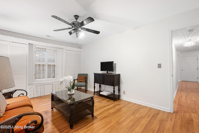 living room with ceiling fan and light wood-type flooring