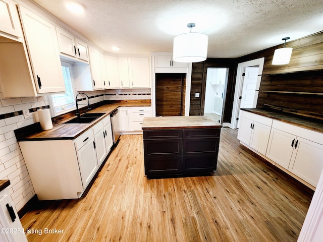 kitchen featuring hanging light fixtures and white cabinets