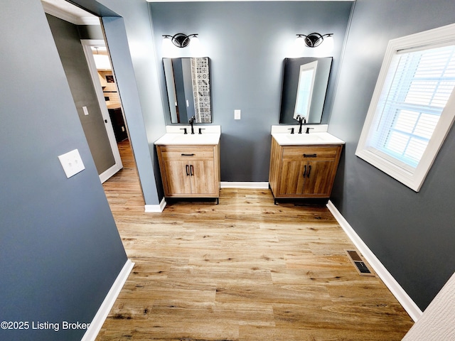 bathroom with vanity and hardwood / wood-style floors