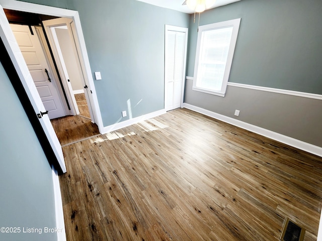 unfurnished bedroom featuring hardwood / wood-style floors and a closet