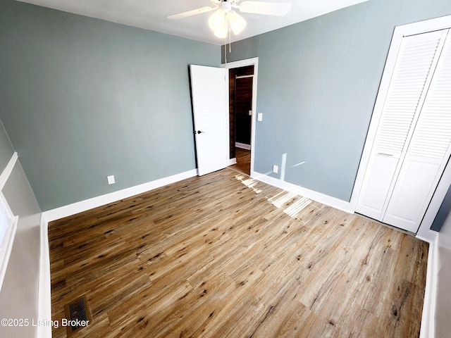 unfurnished bedroom with ceiling fan, light hardwood / wood-style floors, and a closet