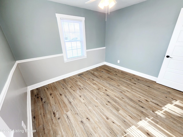 empty room with wood-type flooring and ceiling fan