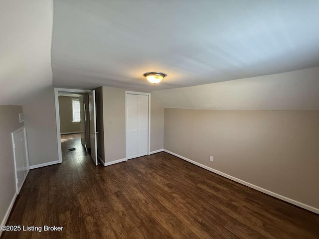 bonus room featuring dark hardwood / wood-style flooring and vaulted ceiling