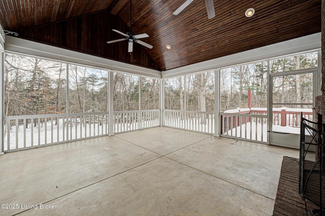 unfurnished sunroom with ceiling fan and lofted ceiling