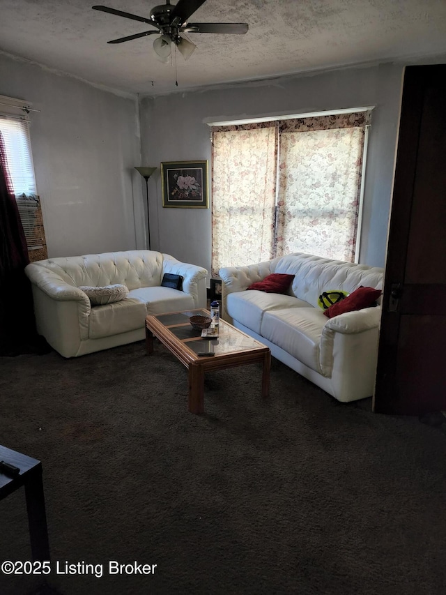 living room with ceiling fan, a textured ceiling, and carpet