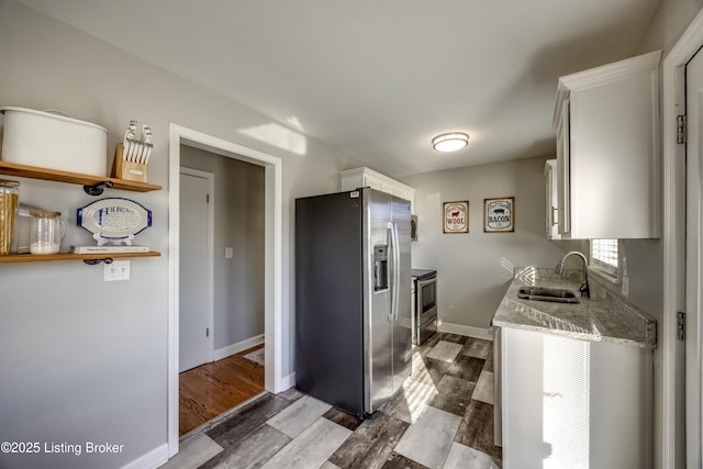 kitchen with white cabinets, hardwood / wood-style flooring, and appliances with stainless steel finishes