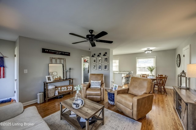 living room featuring ceiling fan and light hardwood / wood-style flooring